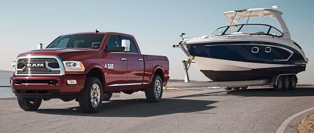 Pickup Towing a Boat on the road